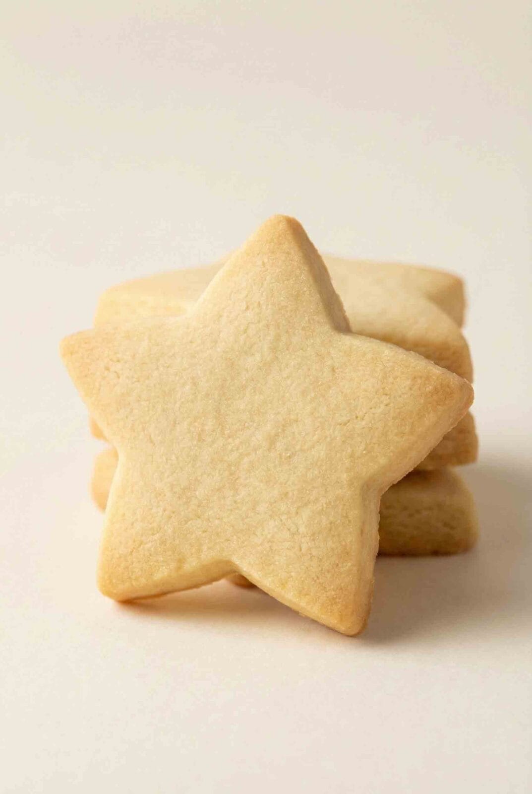 Star-shaped 3-Ingredient Shortbread Cookies stacked together, showing smooth baked surfaces and a classic buttery shortbread texture