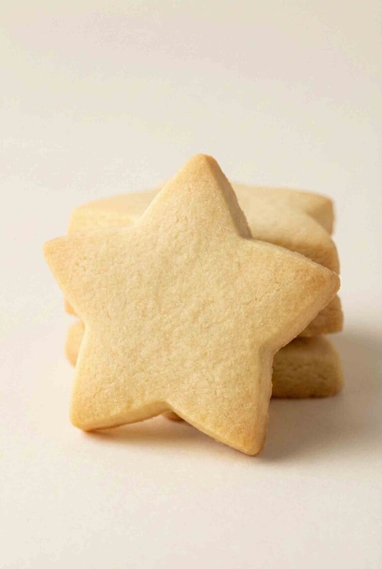 Star-shaped 3-Ingredient Shortbread Cookies stacked together, showing smooth baked surfaces and a classic buttery shortbread texture