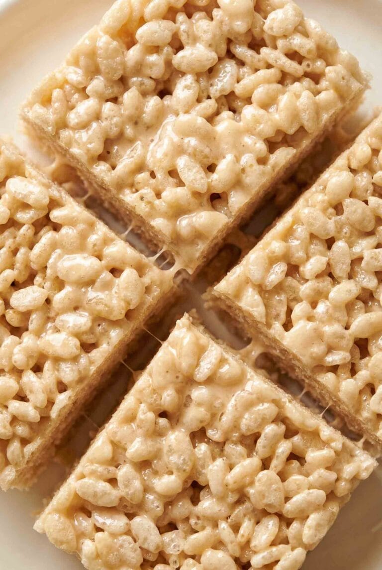 Classic Rice Krispie Treats cut into neat squares, coated in shiny marshmallow with airy puffed rice texture and clean edges