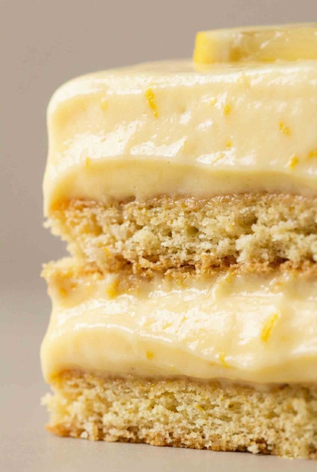 Close-up of Lemon Icebox Cake showing thick lemon cream and tender cookie layers with exaggerated texture and clean alignment